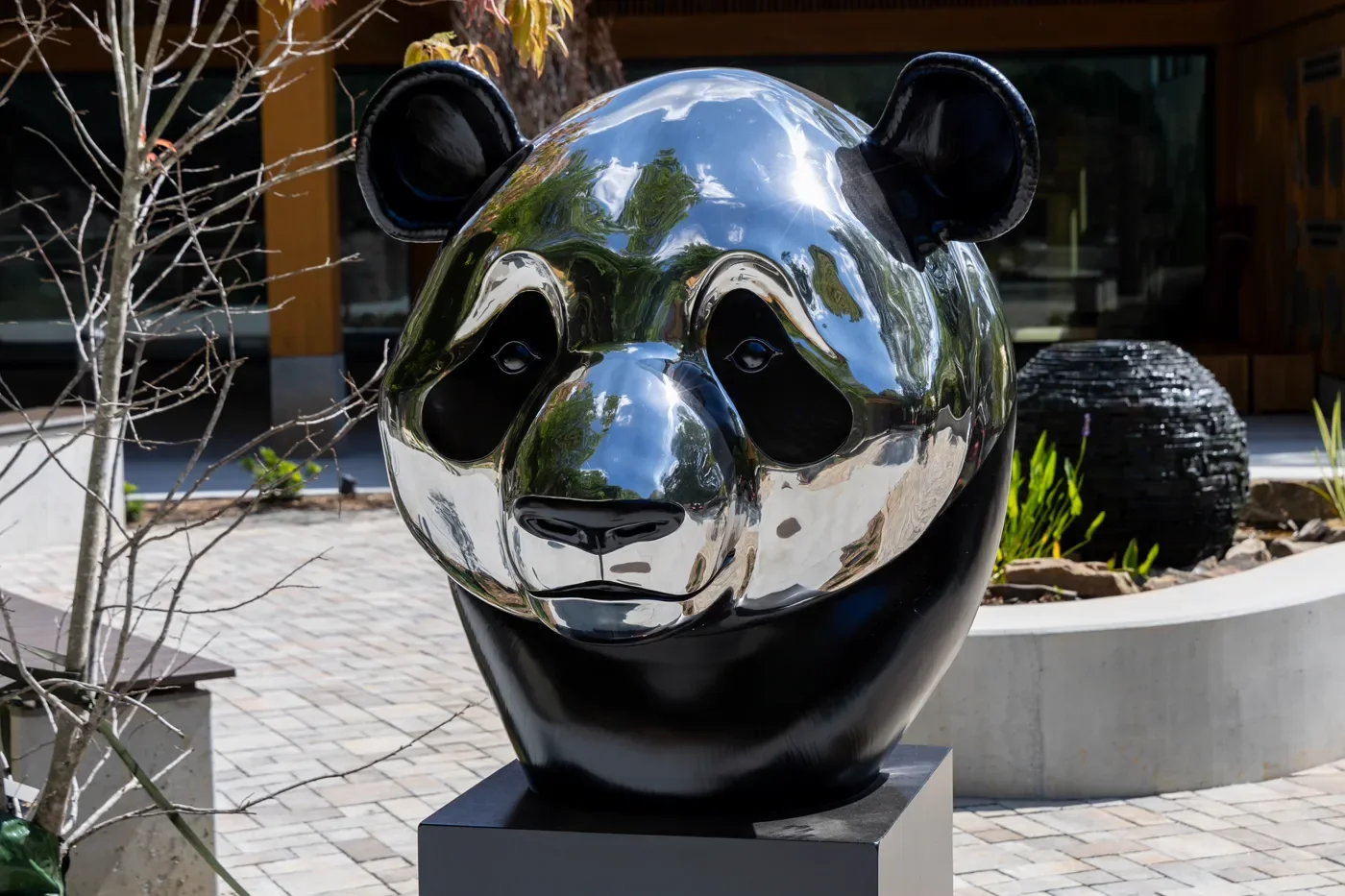 A polished panda-head sculpture on the plaza of Zoo Atlanta's Arthur M. Blank Panda Grove.